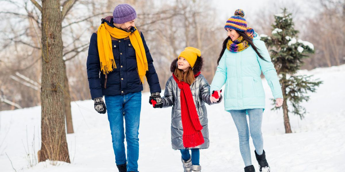 Full length photo of family mommy daddy daughter walk park winter snowy day hold hands happy positive smile